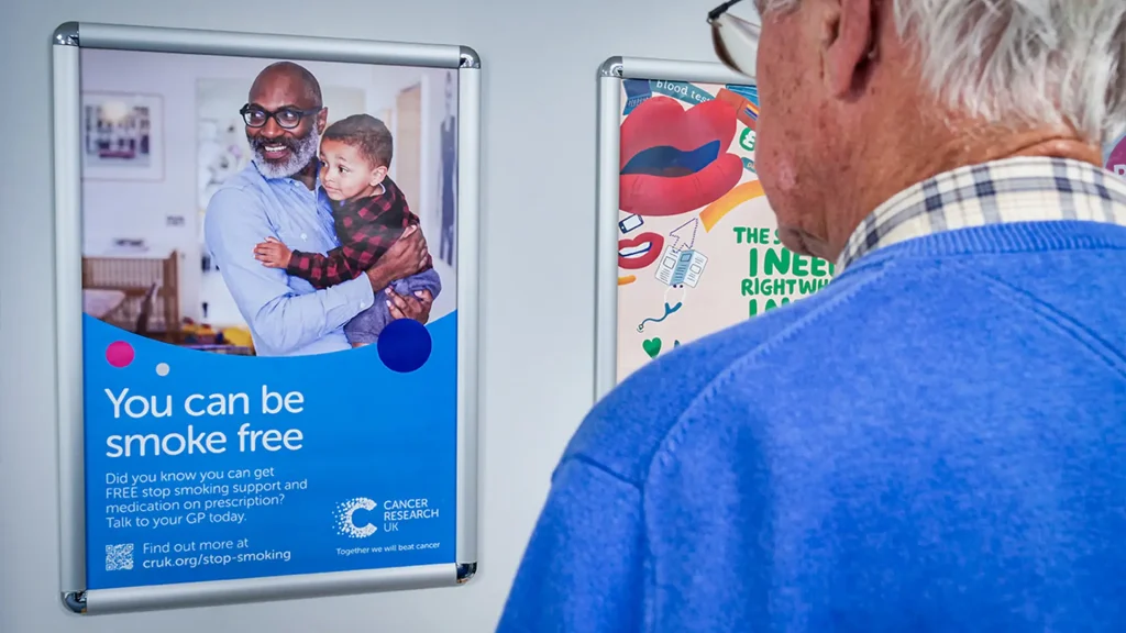 Patient looking at a poster in a GP waiting room